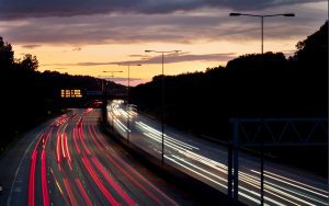 UL-approved cables - UK motorway at dusk with light trails showing fast-moving logistics and transport infrastructure– Quadrant Cables